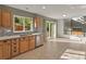 Bright kitchen featuring tan cabinetry, mosaic tile backsplash, and a stainless steel dishwasher at 16212 Blueleaf Pl, Parker, CO 80134