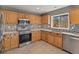 Modern kitchen featuring stainless appliances and tiled backsplash at 16212 Blueleaf Pl, Parker, CO 80134