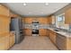 Spacious kitchen with stainless steel appliances, granite countertops, and light wood cabinets at 16212 Blueleaf Pl, Parker, CO 80134