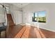 Open floor plan with hardwood floors, staircase, and sunlit windows at 16212 Blueleaf Pl, Parker, CO 80134