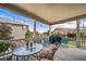 Enjoy the outdoors on this covered back porch with comfortable seating and string lights at 5439 Innisbrook Loop, Elizabeth, CO 80107