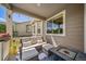 Relaxing covered back porch with a comfortable seating area and a fire pit, perfect for outdoor entertaining at 5439 Innisbrook Loop, Elizabeth, CO 80107