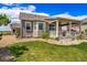 Spacious backyard featuring a well-maintained lawn, covered patio, and rock landscaping at 5439 Innisbrook Loop, Elizabeth, CO 80107