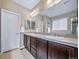 Double sink vanity with tile countertop and ample cabinet space in this well-lit bathroom at 5439 Innisbrook Loop, Elizabeth, CO 80107