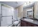 Clean bathroom featuring a glass-enclosed shower, a sleek vanity, and a well-lit mirror with neutral walls at 5439 Innisbrook Loop, Elizabeth, CO 80107