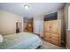 Bedroom with ensuite bathroom, closet and TV atop a wooden dresser at 5439 Innisbrook Loop, Elizabeth, CO 80107
