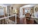 Inviting entryway features hardwood floors, an elegant staircase, and a dining room with stylish wainscoting at 5439 Innisbrook Loop, Elizabeth, CO 80107