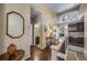 Open hallway featuring wood floors, neutral decor, and easy access to the bathroom at 5439 Innisbrook Loop, Elizabeth, CO 80107