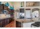 Spacious kitchen with dark cabinetry, stainless steel appliances, and breakfast bar seating area at 5439 Innisbrook Loop, Elizabeth, CO 80107