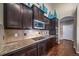 Well-equipped kitchen featuring granite countertops, dark cabinets, and stainless steel appliances at 5439 Innisbrook Loop, Elizabeth, CO 80107
