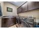 Convenient laundry room equipped with modern, front-loading washer and dryer and plenty of storage space at 5439 Innisbrook Loop, Elizabeth, CO 80107
