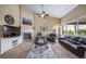 Bright living room features high ceilings, large windows, a fireplace, and comfortable seating at 5439 Innisbrook Loop, Elizabeth, CO 80107