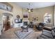 Open-concept living room with a fireplace, and a large seating arrangement at 5439 Innisbrook Loop, Elizabeth, CO 80107