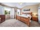 Comfortable primary bedroom features vaulted ceilings, carpet, and lots of natural light at 5439 Innisbrook Loop, Elizabeth, CO 80107
