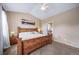 Vaulted ceiling bedroom featuring carpet flooring, a fan, and en suite bathroom access at 5439 Innisbrook Loop, Elizabeth, CO 80107