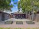Charming backyard with a covered patio, garden beds, and gravel landscaping at 3050 S Delaware St, Englewood, CO 80110