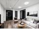 Modern basement living room with recessed lights, light gray couch, and accent wall at 3050 S Delaware St, Englewood, CO 80110