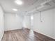 Finished basement with vinyl floors, white walls, and bright lighting, offering versatile space at 3050 S Delaware St, Englewood, CO 80110