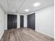 Spacious basement featuring modern vinyl floors, two closets, and neutral paint palette at 3050 S Delaware St, Englewood, CO 80110