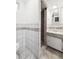 Compact bathroom with tiled shower and vintage vanity at 3050 S Delaware St, Englewood, CO 80110