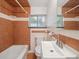 Cozy bathroom featuring white fixtures, a tiled shower, and a vanity with a mirror at 3050 S Delaware St, Englewood, CO 80110