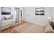 Bright bedroom featuring hardwood floors, neutral decor, and arched doorways at 3050 S Delaware St, Englewood, CO 80110