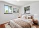 Cozy bedroom with hardwood floors, neutral tones, and natural light at 3050 S Delaware St, Englewood, CO 80110