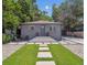 Charming home with gray exterior, stone walkway, and lush green lawn at 3050 S Delaware St, Englewood, CO 80110