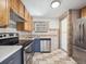 Efficient kitchen with stainless steel appliances and wood cabinets at 3050 S Delaware St, Englewood, CO 80110