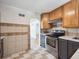 Well-lit kitchen featuring stainless steel appliances and tile backsplash at 3050 S Delaware St, Englewood, CO 80110