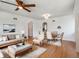 Open concept living room with hardwood floors, large windows, and arched doorways at 3050 S Delaware St, Englewood, CO 80110