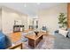 Open living room with hardwood floors and views into the dining area and kitchen at 3117 N Marion St, Denver, CO 80205