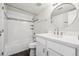 Bathroom features a modern vanity, stylish round mirror, and shower with decorative tile accent at 4273 S Salida Way # 1, Aurora, CO 80013