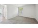 Empty bedroom featuring a window providing natural light and neutral carpeting at 4273 S Salida Way # 1, Aurora, CO 80013