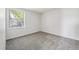 Empty bedroom featuring a window providing natural light and neutral carpeting at 4273 S Salida Way # 1, Aurora, CO 80013
