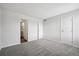 Spacious bedroom features gray carpet, white walls and trim, and a bathroom entryway at 4273 S Salida Way # 1, Aurora, CO 80013