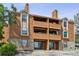Exterior view of a multi-story condominium with balconies and stone accents at 4273 S Salida Way # 1, Aurora, CO 80013