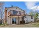 View of the home's back exterior with a deck and patio space at 7140 S Reed Ct, Littleton, CO 80128
