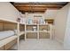 Unfinished basement space with shelves and storage for home improvement supplies at 7140 S Reed Ct, Littleton, CO 80128