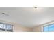 Image of an unfurnished room with two windows allowing natural light at 7140 S Reed Ct, Littleton, CO 80128