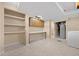 Utility room with storage shelves, cabinetry, a water heater, and a washer at 7140 S Reed Ct, Littleton, CO 80128