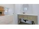 Bathroom area featuring modern sink, vanity and an oval mirror at 7140 S Reed Ct, Littleton, CO 80128