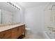 Bright bathroom featuring vanity with sink and toilet with white tile at 7140 S Reed Ct, Littleton, CO 80128