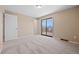 This bedroom offers plush carpet, and sliding door access to a wood patio at 7140 S Reed Ct, Littleton, CO 80128