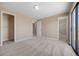This bedroom features neutral walls, carpet, two closets, and access to a private bathroom at 7140 S Reed Ct, Littleton, CO 80128
