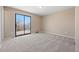 This bedroom offers plush carpet, and sliding door access to the backyard at 7140 S Reed Ct, Littleton, CO 80128
