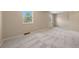 Comfortable bedroom offers natural light from two windows and wall-to-wall carpet at 7140 S Reed Ct, Littleton, CO 80128