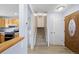 Welcoming entryway with wood-look floors, leading to the stairs and kitchen on the left at 7140 S Reed Ct, Littleton, CO 80128