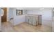 Inviting entryway and view into carpeted dining area with hardwood floors in foyer at 7140 S Reed Ct, Littleton, CO 80128