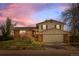 Charming two-story home featuring a brick facade and attached two-car garage at 7140 S Reed Ct, Littleton, CO 80128